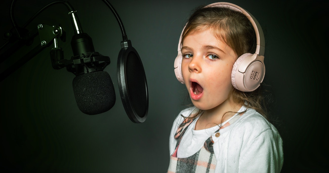 young child singing into a microphone
