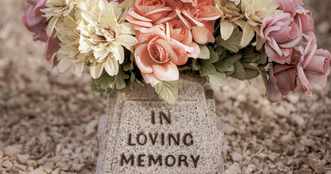 flowers on a tombstone header reading in loving memory