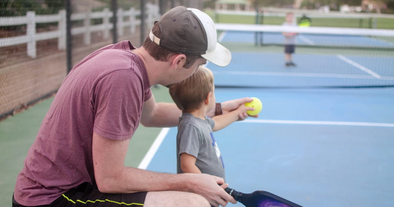 Dad with son playing pickleball