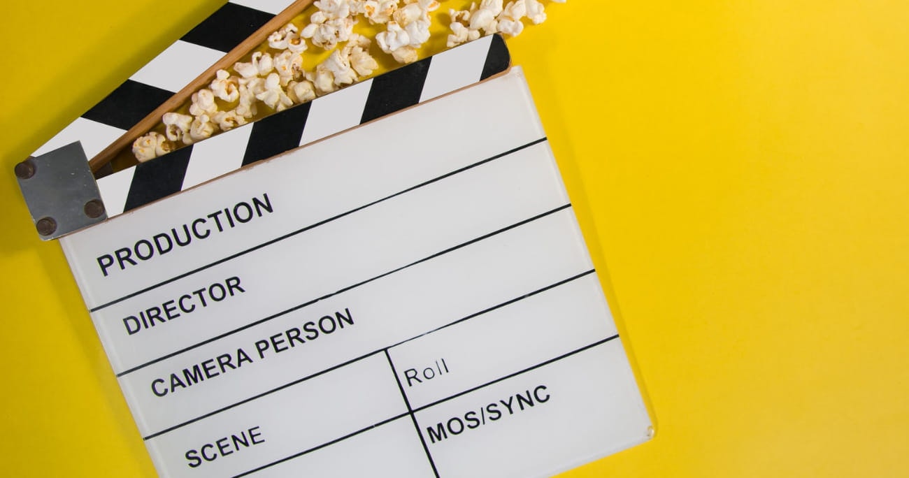 movie slate against a yellow background