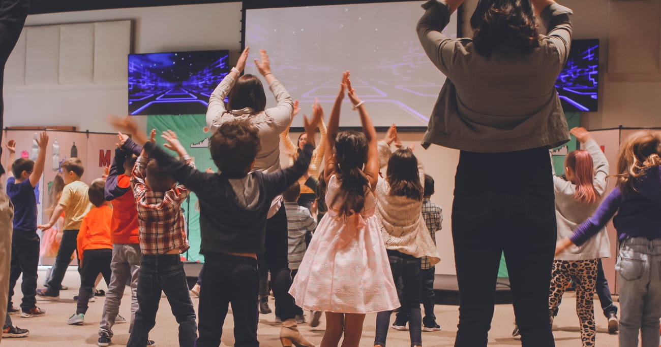 children singing and clapping at a church event